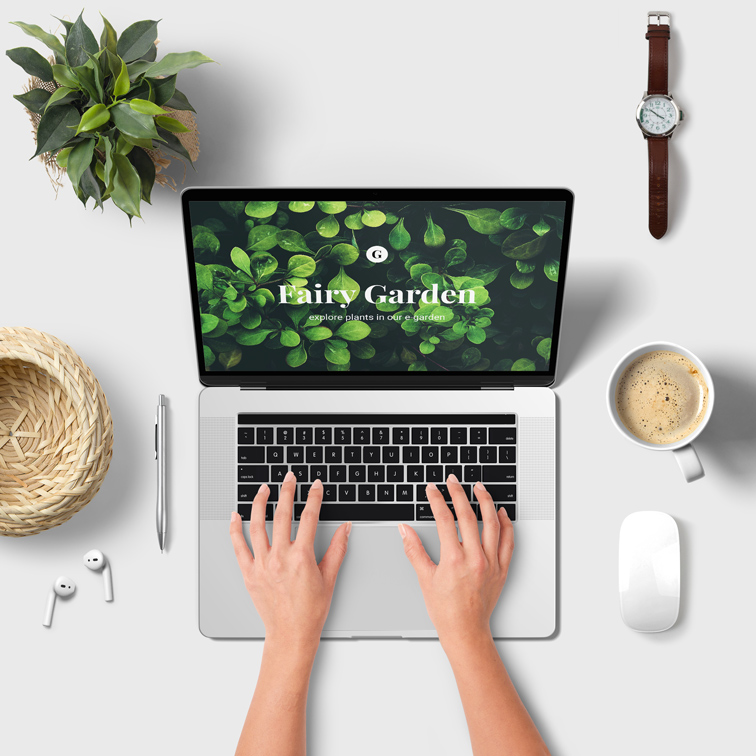 Hands Using Laptop on a Workspace