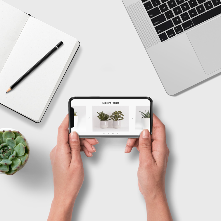 Hands Holding iPhone at White Desk