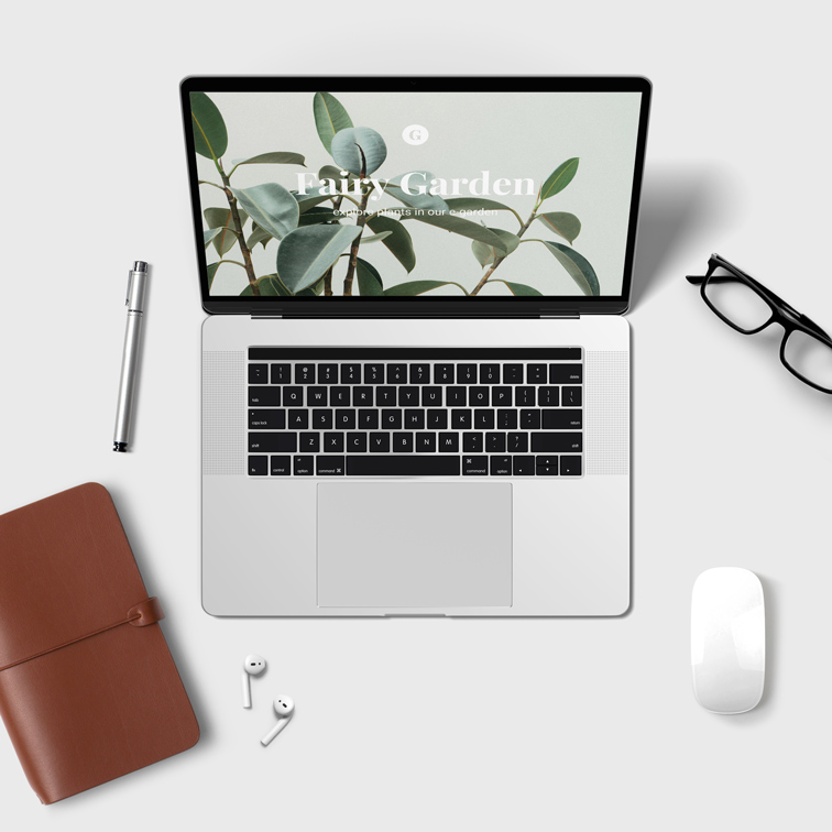 Laptop, Magic Mouse, and AirPods on a Desk