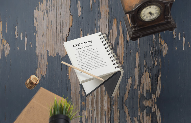 Spiral Sketchbook on an Old Wooden Background