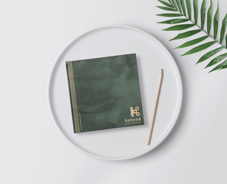 Square Sketchbook and a Pencil with a Plant