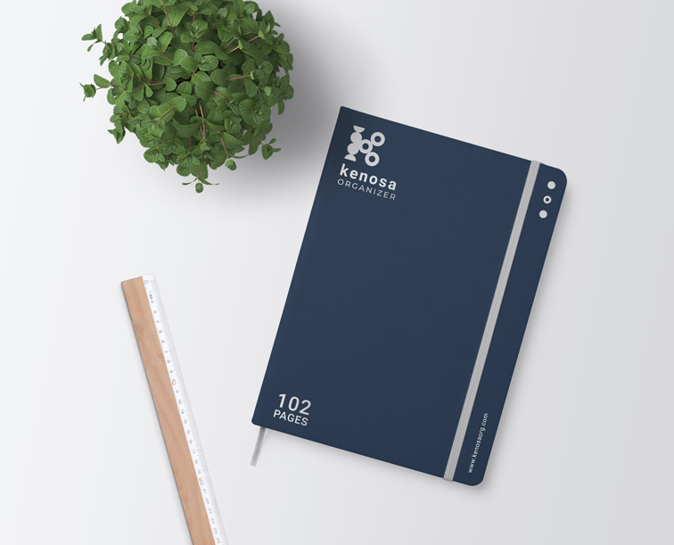 Elastic Band Sketchbook, a Ruler, and a Plant