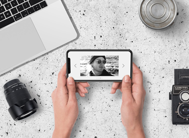 Hands holding an iPhone at a Photographer Desk