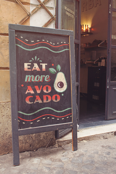 Vertical Sign in front of a Cafe