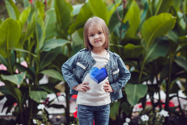 Little Girl with Big Plants Behind