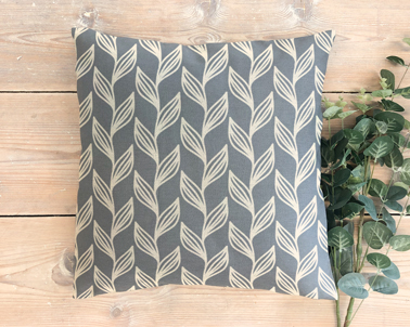 Cushion with Plants on a Wooden Background