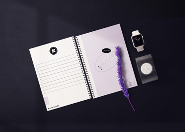 Spiral Sketchbook, Smartwatch, and a Candle