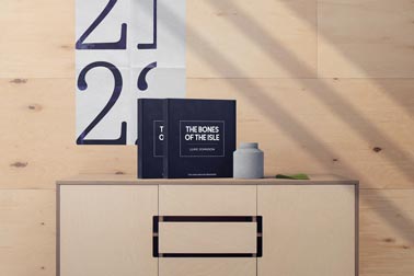 Two Hardcover Books and a Vase Decor on a Cabinet