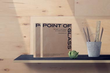 Two Square Books and Stationery on a Shelf