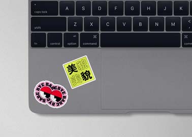 Two Stickers on a MacBook Keyboard