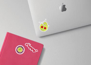 Stickers on a MacBook and Notebook