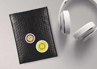 Stickers on a Package Next to a Headphone