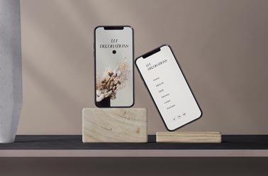 Two iPhones on Wooden Stands of a Desk