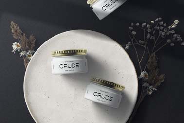 Three Cosmetic Jars Next to Dry Plants