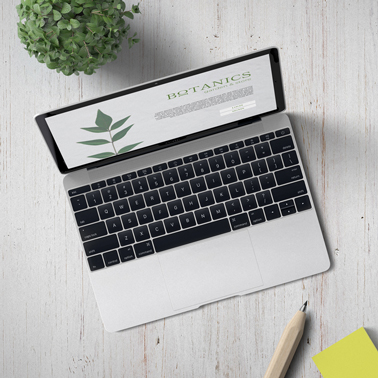 MacBook on a White Wooden Desk Top View