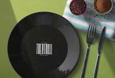 Logo sur une assiette à côté des couverts et des épices 