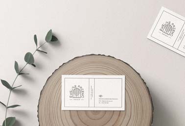 Two Business Cards, One on a Log