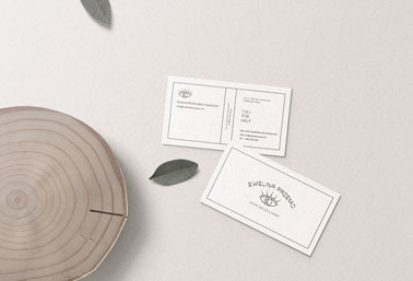 Two Business Cards Next to a Log