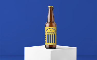 Beer Bottle on a Podium Against the Wall