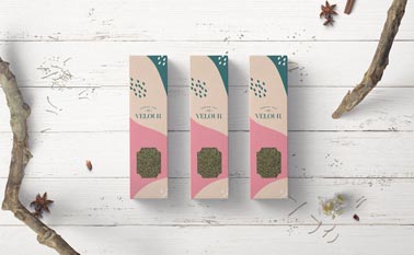 Three Slim Tea Packages on a Wooden Background