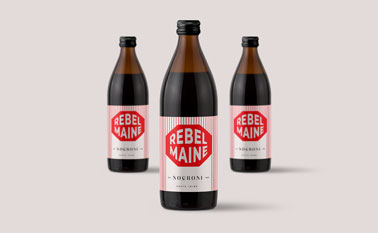 Three Glass Bottles on a Beige Surface