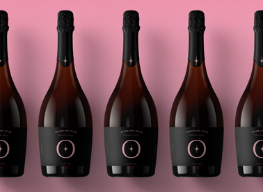 Multiple Champagne Bottles on a Pink Surface