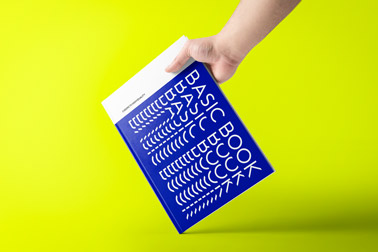 Hand Holding a Book Tilted to the Left