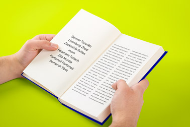 Hand Holding an Open Book Side View