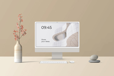 iMac Set Next to a Flower Vase and Stone Decors