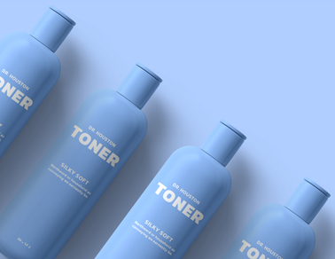 Four Toner Containers on a Blue Surface