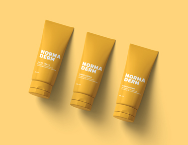 Three Cream Tubes on a Yellow Surface