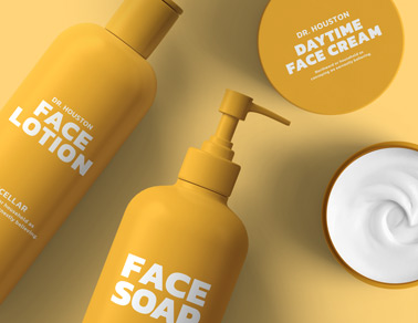 Four Cosmetic Containers on a Yellow Surface