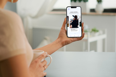 A Female Holding an iPhone 13 Front View
