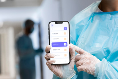 A Doctor Holding an iPhone 13 with Gloves