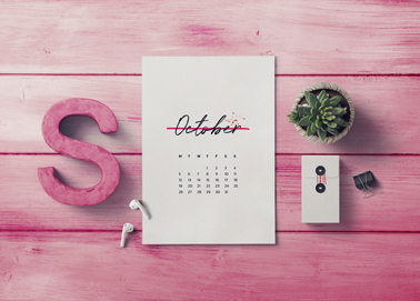 A Calendar With Earphones and a Plant