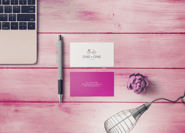 A Pen and Business Cards on a Wooden Desk