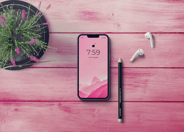 An iPhone with Airpods, a Pencil, and a Plant