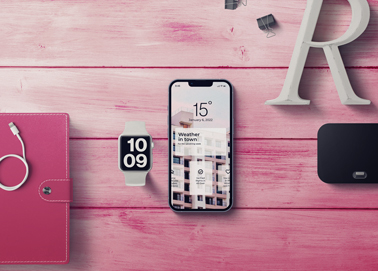 An iPhone With an Apple Watch and Stationery