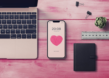 An iPhone With a Macbook and a Wallet