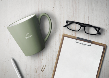 Coffee Mug With Glasses and a Paper Pad