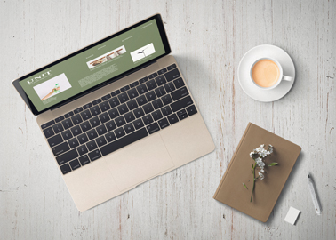 MacBook With a Notebook and a Coffee Cup