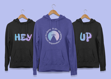 Three Hoodies Hanging on Wooden Hangers