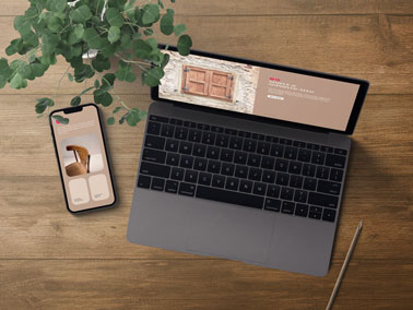 Laptop With a Cell Phone and a Plant