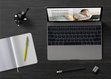 MacBook With a Notebook and Pens