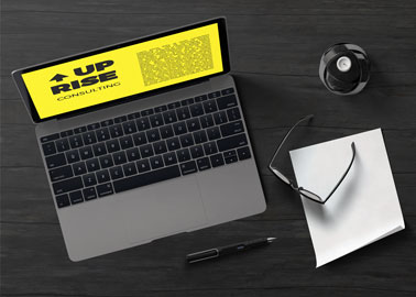 MacBook With Glasses, Paper, and a Pen