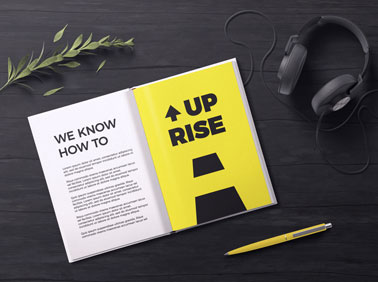 Open Magazine With Headphones and a Pen