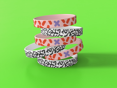 A Stack of Wristbands on a Neutral Background