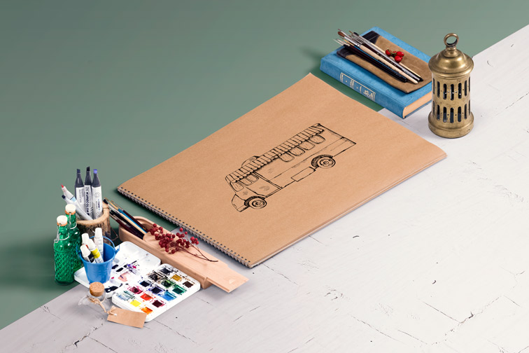 Brown Sketchbook Next to Drawing Tools