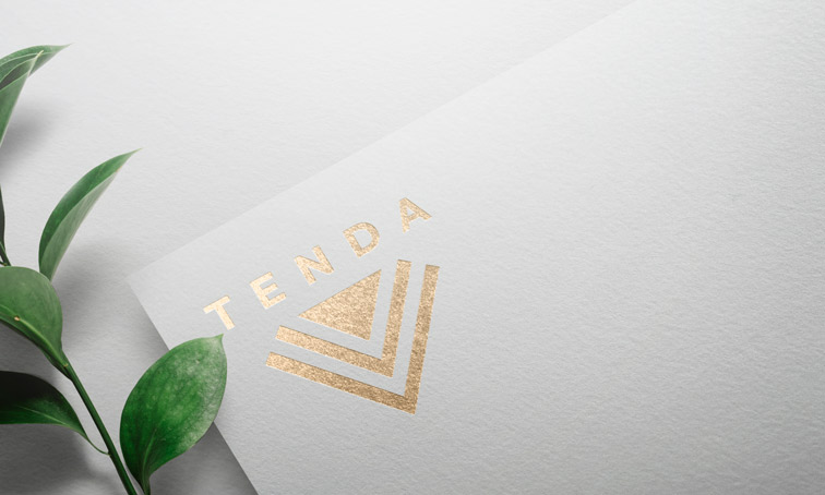 Logo on White Paper Next to Plant