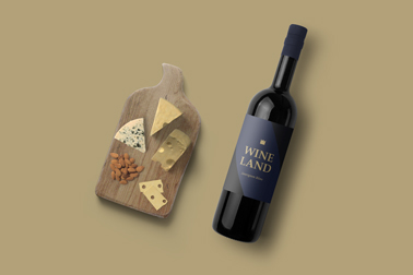 A Bottle of Red Wine and a Cheese Board Top View